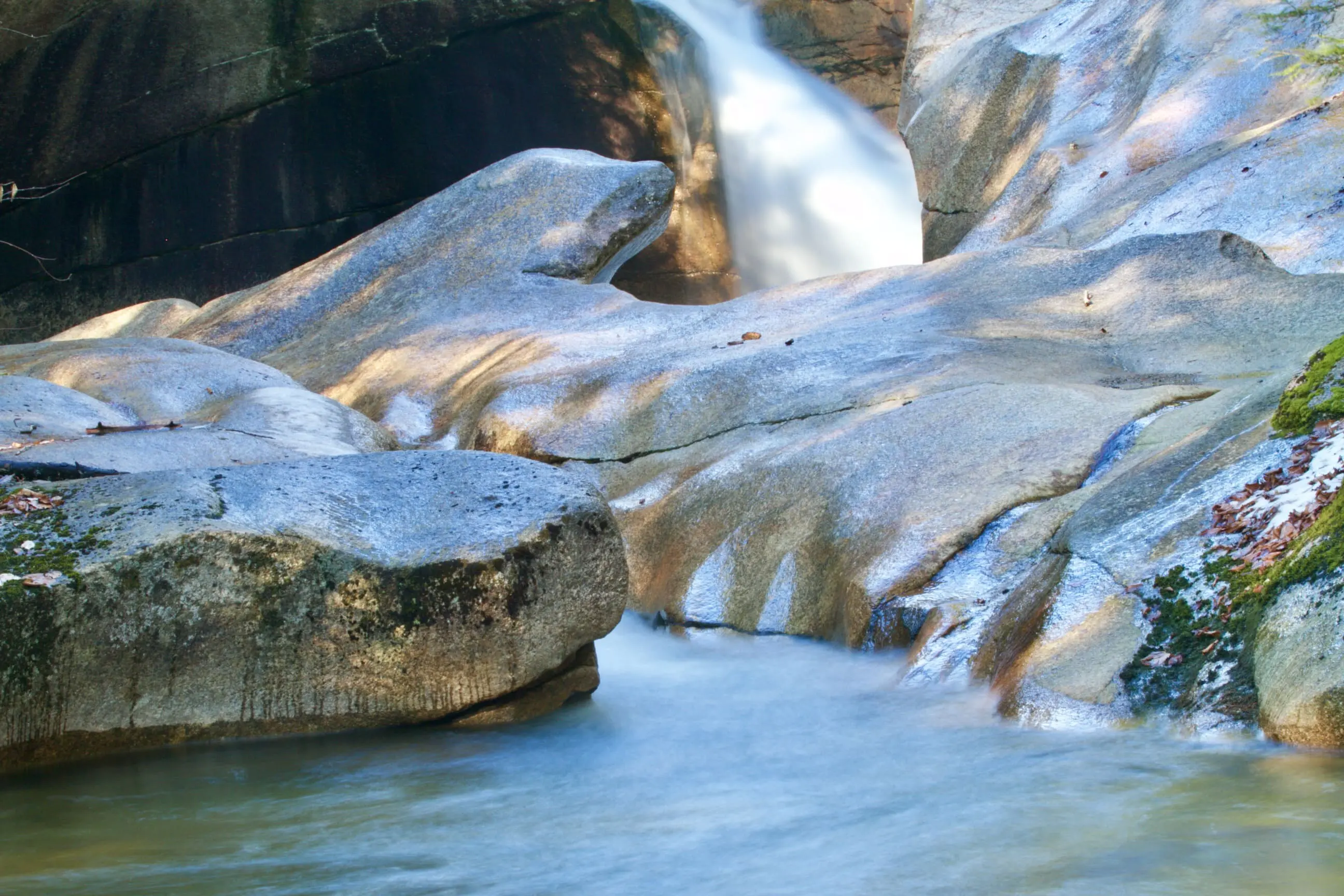 A waterfall with rocks in the water