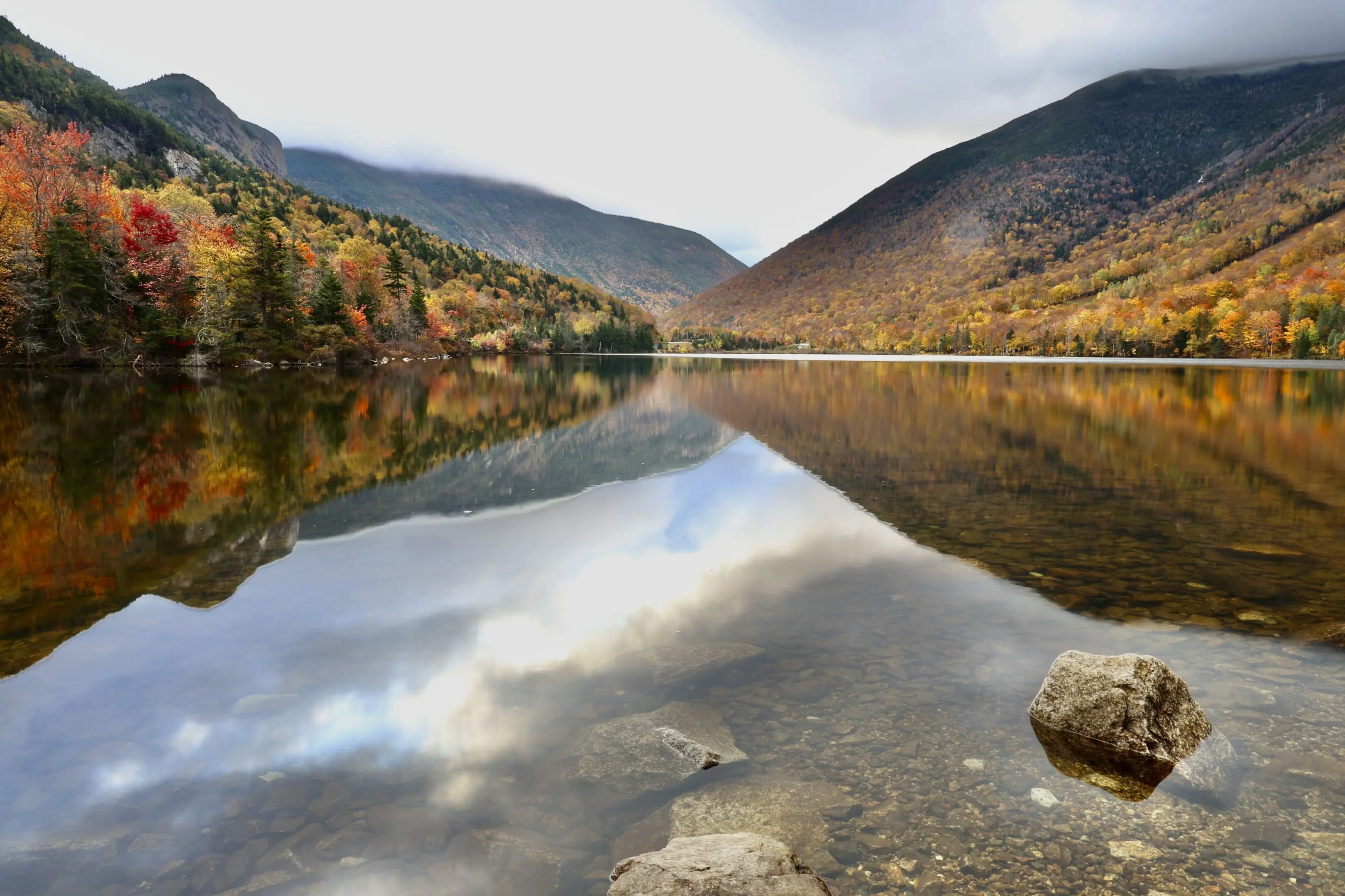 A body of water with mountains in the background.