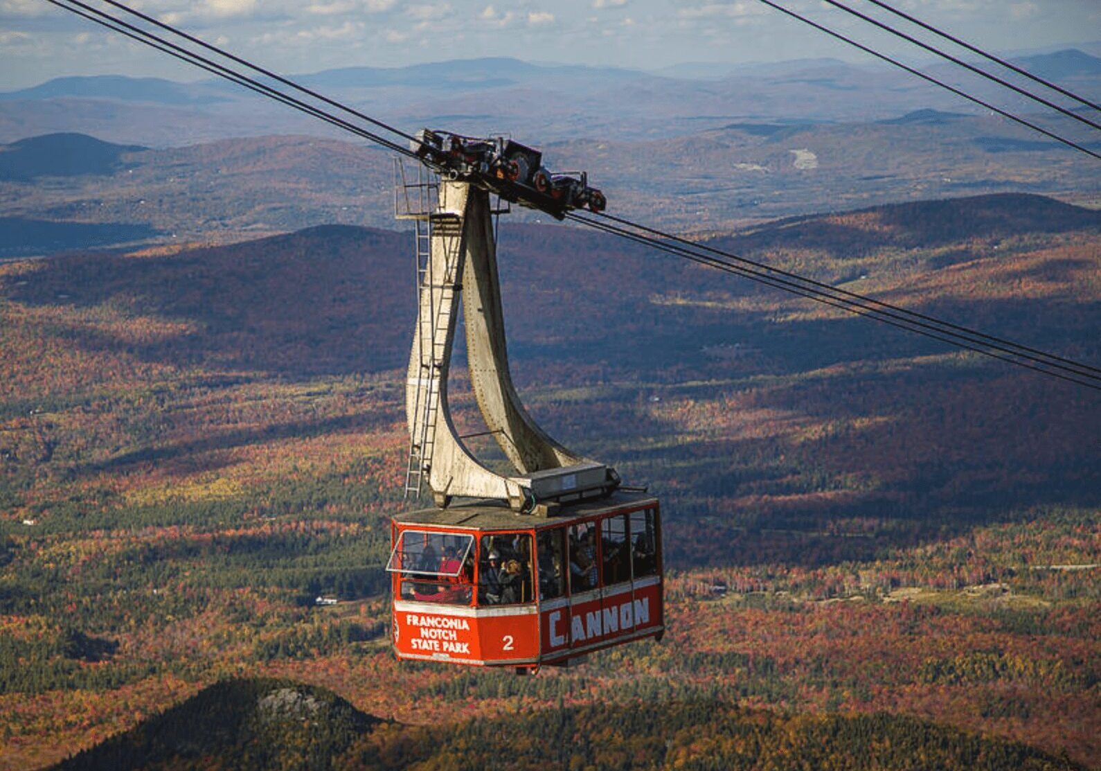 A cable car is going up the mountain