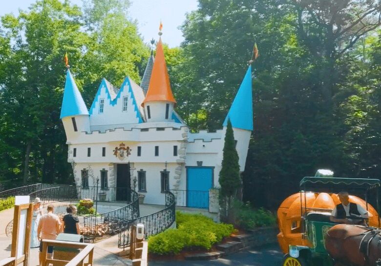 A large building with three towers and a turrets.